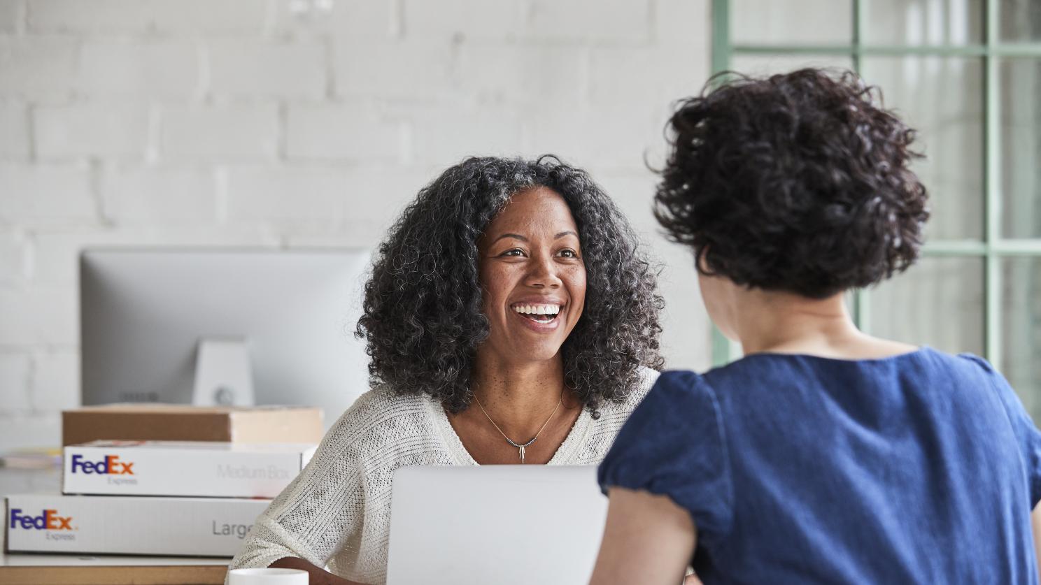 Woman in an office smiling with a coworker